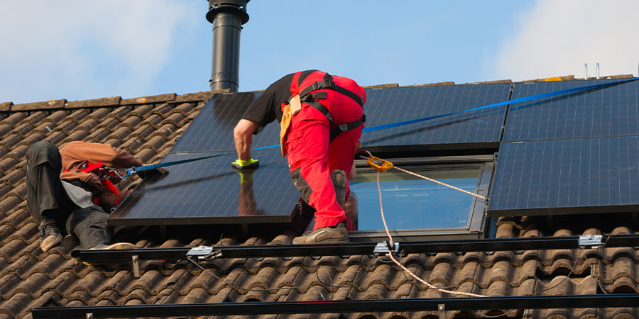 service technicians on roof installing solar panels